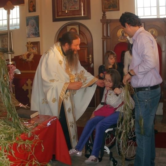 Children receiving bells and willwo branches