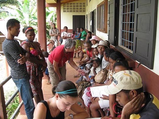Cass doing triage with the waiting patients and family.