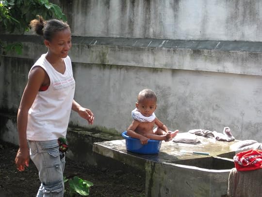 Mother bathing her baby before coming to clinic.