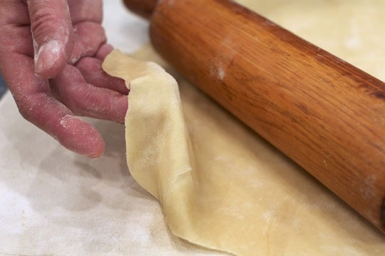 Knish dough, enriched with schmaltz, rolled super thin to wrap potato and gribenes.