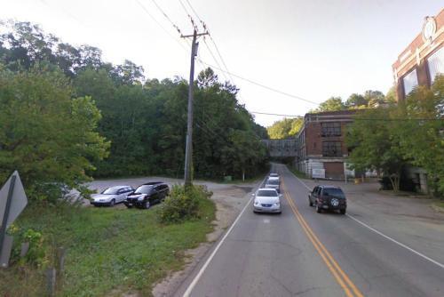 The small gravel parking area across the street.