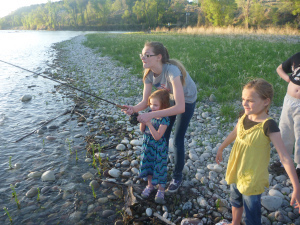 Nessy helps Lily reel in a nice trout. 