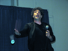A goofy looking Neil Gaiman throwing buttons into the crowd.