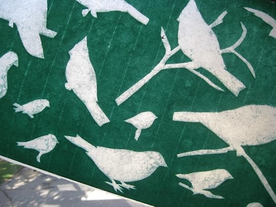 Laminated green silhouette couched onto a white base sheet.