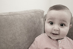 an infant on a couch smiling