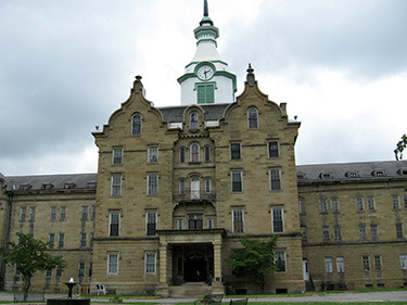 The imposing entrance. Note the restored clock tower on top. It only has clock faces on three sides; the fourth faced the direction of the fields some inmates worked in order to supply the asylum with food. Without a clock, they had no way of knowing how long they had been working, other than the change in sunlight.