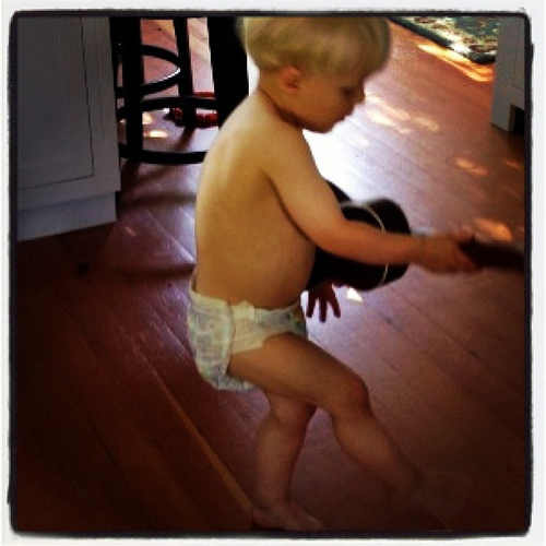 He's been practicing his moves. Yesterday he was strumming the guitar while playing the harmonica at the same time. When he blew hard, the harmonica flew out of his mouth and he thought that was hilarious. It's a joy to witness his joy with his musical in