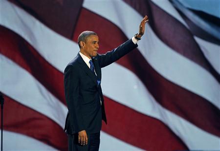 U.S. President Barack Obama, who won a second term in office by defeating Republican presidential nominee Mitt Romney, waves as he addresses supporters during his election night victory rally in Chicago, November 7, 2012. REUTERS/Jim Bourg