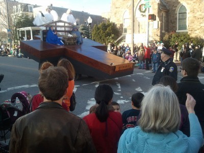 Hampden Christmas Parade -- giant cross float with manger scene on top
