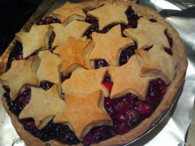 A fully cooked, whole cranberry-cherry pie