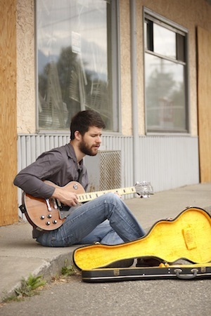 andrew-playing-guitar-in-front-of-old-ice-cream-shop