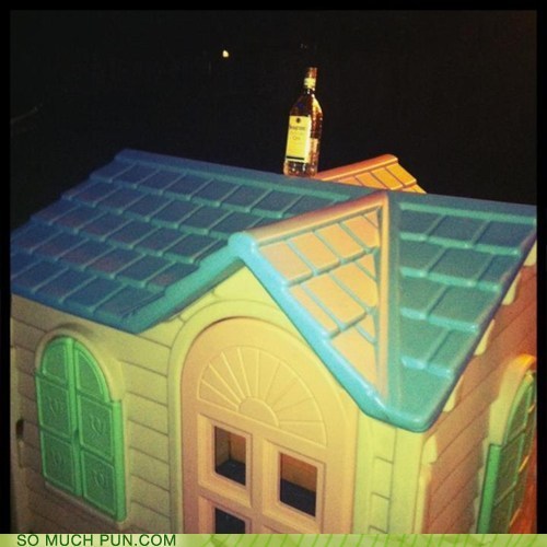 Photo of a bottle of booze on top of a doll house...drinks are on the house