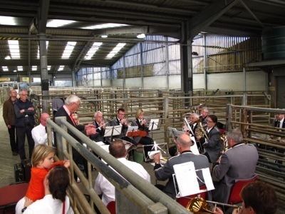 Yes, that's a brass band (a great one) in a sheep pen.