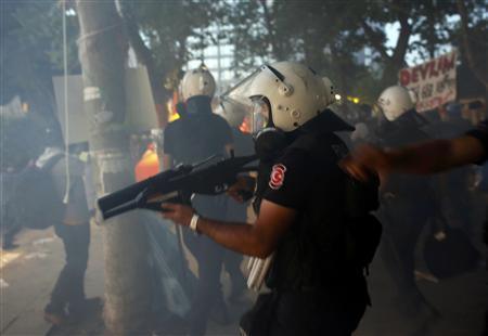 Riot police enter Gezi Park at Taksim Square in Istanbul