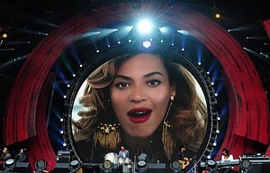 A video from singer Beyonce is projected durin...