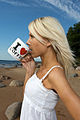 80px-Blond_woman_on_a_white_dress_on_the_beach_drinks_from_a_cup