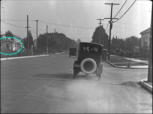 Notice the little girl watching, sitting on the corner, and the telephone lineman above her.