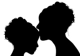 silhouette of mother kissing her daughter