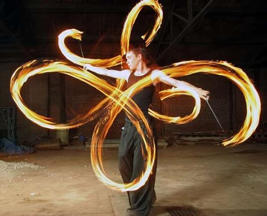 Poi ball dancer with fire trails