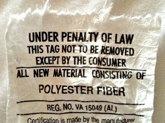 DO NOT REMOVE UNDER PENALTY OF LAW pillow tag