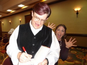 James Owen is too busy drawing dragons in book inscriptions to notice I'm sneaking up behind him. (At the ANWA Conference, Arizona, 2013)