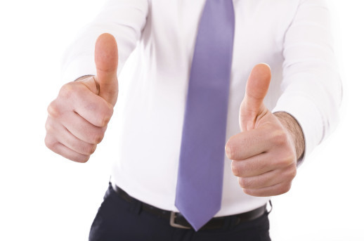 Business man showing Victory sign.