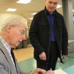 Colin Lyle signing a book for a current Tate & Lyle worker