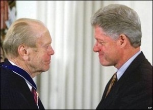 Photo of Presidents Clinton and Ford looking at each other