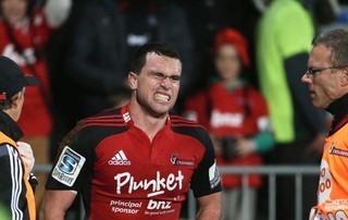 Tom Marshall of the Crusaders pulls a face in pain