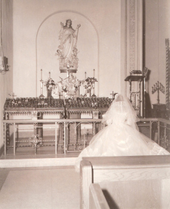 My mother, a new bride, praying in front of the Blessed Mother statue. 1955. copyright Ellen Hrkach