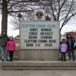 The Lions' sign in town announces the reading with Alex, Katherine, Anna, and Bryan