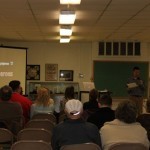 Visitors listen as Andrew Winkel explains the origins of Raceboy and Super Qwok Adventures