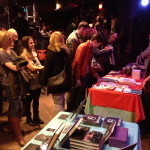 People watch bands, drink beers, buy books