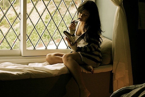 girl writing in window