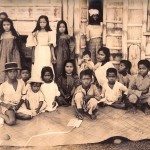 Local children on a banig, a woven mat.