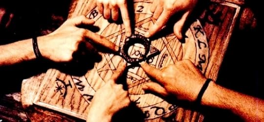 ouija-board-with-hands