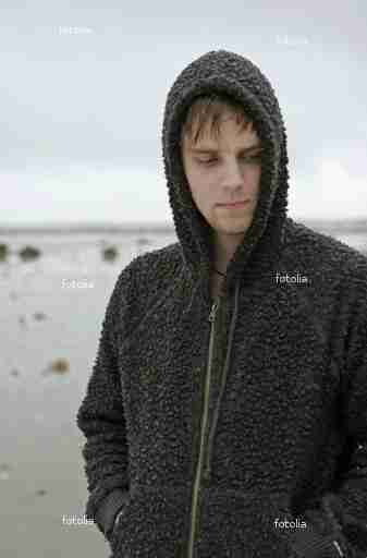 Hooded man at the beach