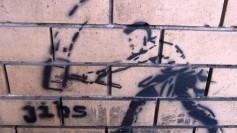 Graffiti of a man swinging a sledgehammer. CC photo by Flickr user 1llustr4t0r.com
