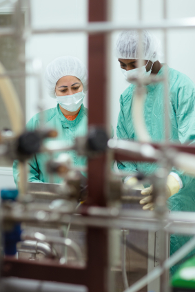 Staff and researchers checking equipment in biotech industry