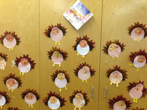 Kids made turkeys from scrapbook paper after reading The Night Before Thanksgiving.