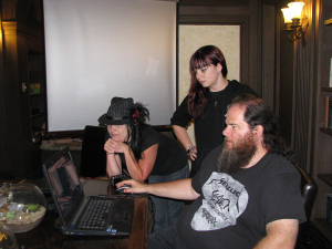 William cleans up EVP recordings on his computer while Diane and Kristin of the GhostGirls look on. Photo by Sephera Giron.