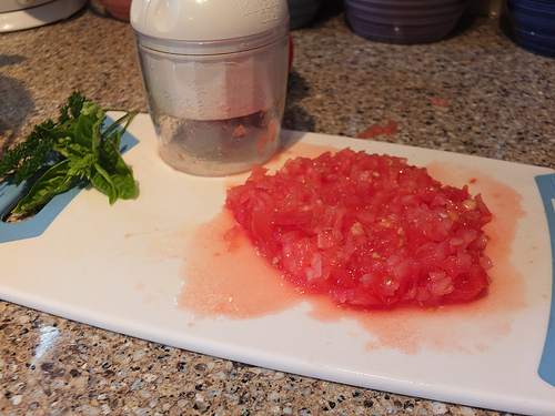 Chopping tomatoes small to make them go in anything