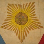 The incredible detail of the sun's face. Also fascinating is the use of a 5-pointed star in this flag, possibly relating to a faction of the Katipunan. The modern design of the Philippine flag as we know it today, conceptualized by Emilio Aguinaldo during his exile in Hong Kong and first flown on May 28, 1898, depicted 8 rays of the sun, representing the provinces placed under martial law by Spain.