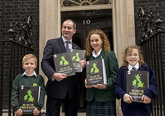 Handover of a book produced by the UK's school...