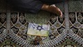 Iranian worshipper with anti-Israel pamphlet