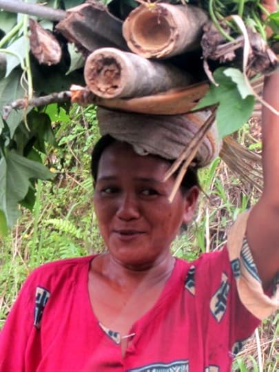 Woman carrying wood in Bali