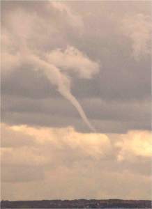 Tendrils of cloud reaching down from the base of thunder clouds towards the ground are the first signs that a tornado is one its way.