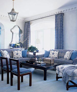 Livingroom with blue walls, floor, furniture, accet pillows and drapes
