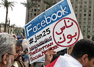 English: A protester holding a placard in Tahr...