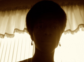 a silhouetted woman with an Afro